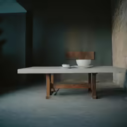 a table with bowls on it and a chair sitting around
