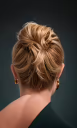 a woman with blonde hair styled into a low bun