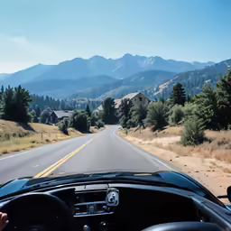 the dashboard of a car is seen as it travels down a road through a wooded area