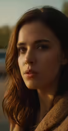 a woman looking down with a serious look on her face