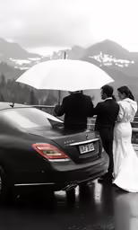 a man and woman that are standing outside with an umbrella