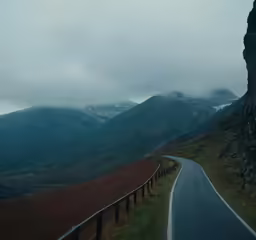 a very nice looking road with mountains in the background