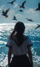 a girl standing near the ocean with birds flying overhead