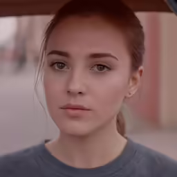 a close up of a young person looking straight ahead