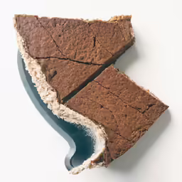 a piece of chocolate cake has a bite missing