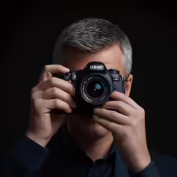 man holding up a camera for a selfie
