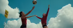 two women are playing volleyball with each other