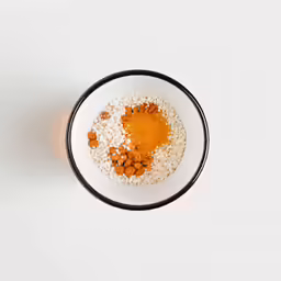 a bowl of food sits on a white table