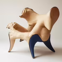 a carved sculpture of a dog on a chair