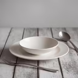 two dishes are placed on a table and ready to be served