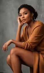 a black woman sitting down on the floor