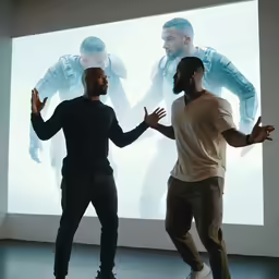 the two men are facing each other as they dance
