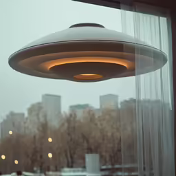 a round lamp that is sitting in a window sill