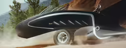 an image of a futuristic vehicle driving on sand