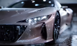 a close up of a modern car on wet floor