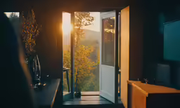 sun coming in through an open door with sunlight shining down
