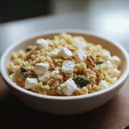 a bowl with corn and cheese is shown here