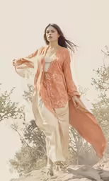 the woman is posing on a large rock