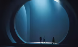 three men standing in a dark tunnel