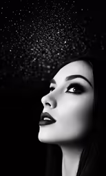 a woman standing under a black umbrella in the rain