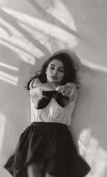a woman in a white top with black bow tie