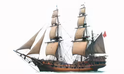 a very tall sailing vessel floating in the water