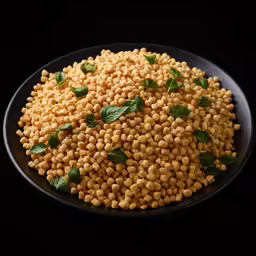 a plate of cooked chickpeas on a black surface