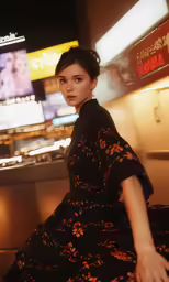 a woman sitting on top of a couch near a theater