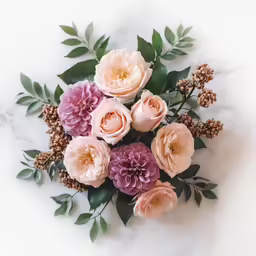 a bouquet of pink and pink roses is displayed on a white marble surface