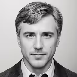a man that is dressed in a suit and tie