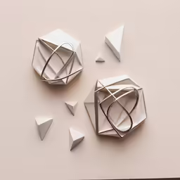 an abstract object made of white paper and paper scissors