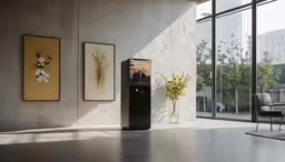 an empty room with plants, chairs and art on the wall