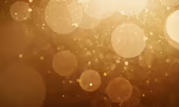 the back side of a blurry picture of some gold circles