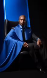 a man sitting on top of a black chair