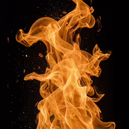 a black background with lots of orange and yellow smoke