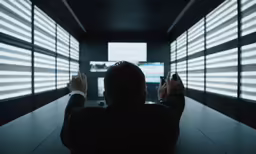 the man is sitting at the table with his laptop