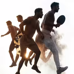 men in shorts are playing with disc in the sun