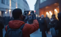 a man taking pictures of something in front of him with a camera