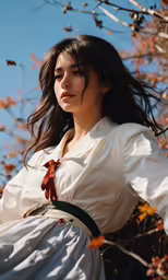 woman in white dress standing on branches looking off to the side