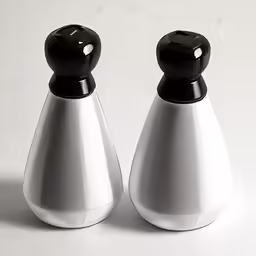two white and black salt and pepper shakers