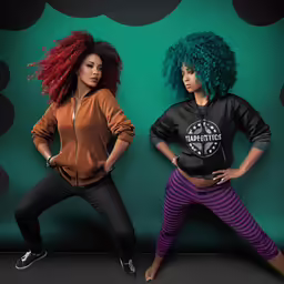 two african american women wearing colorful clothing posing for a picture