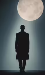 a man standing in the dark with a full moon above
