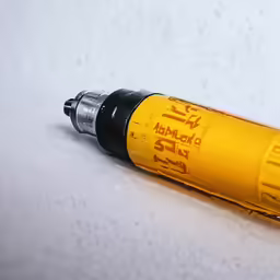 a small screwdriver sits on a white surface