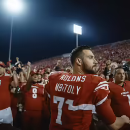a group of people are dressed in red and white uniforms
