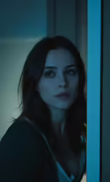 a female in a black shirt leaning up against a wall