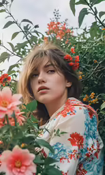 a woman standing in a field of flowers