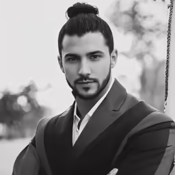 a man with a high ponytail is posed