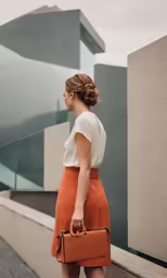 a woman standing on a ledge with a briefcase