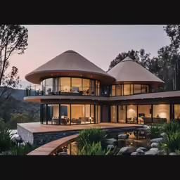 this contemporary villa has an outdoor patio, stone - topped steps, and a pond