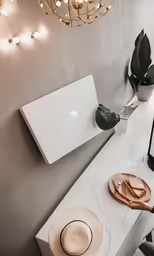 a desk with a laptop and glasses on it